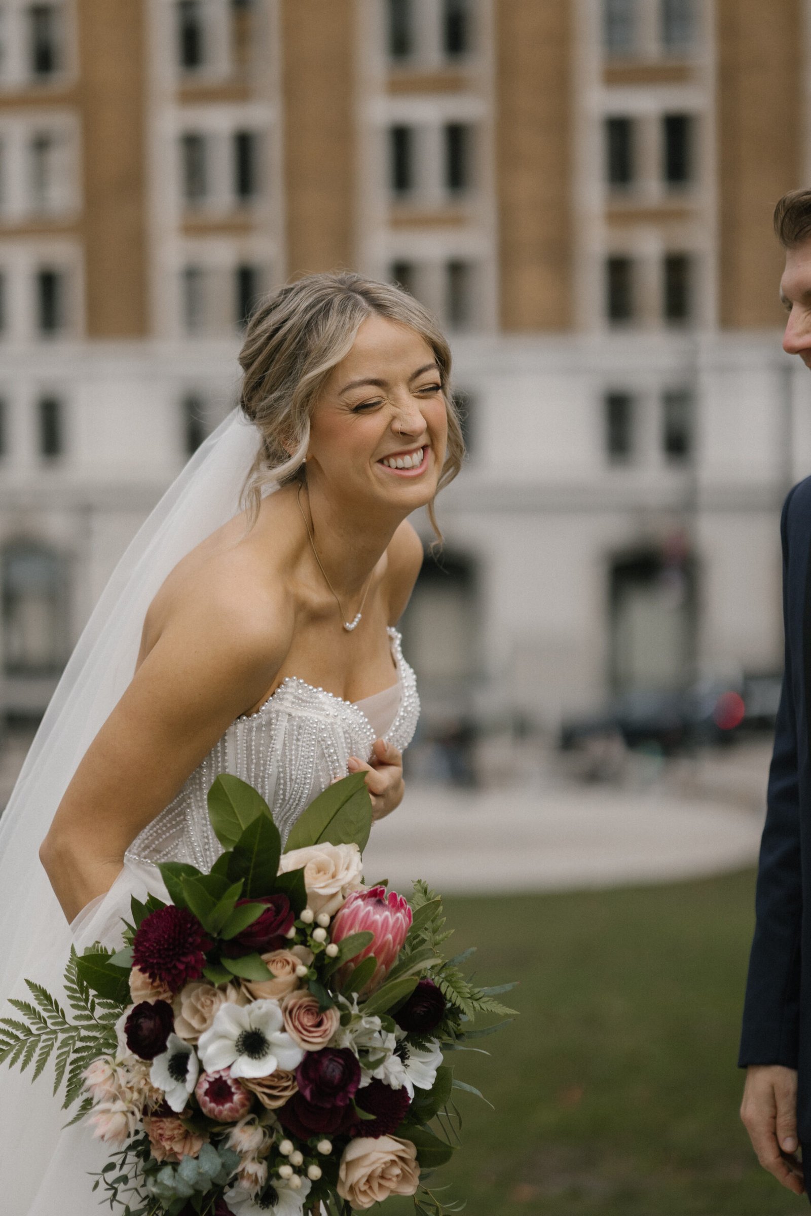 DIY bridal bouquet with fresh protea as focal flower, hand-tied for a wedding